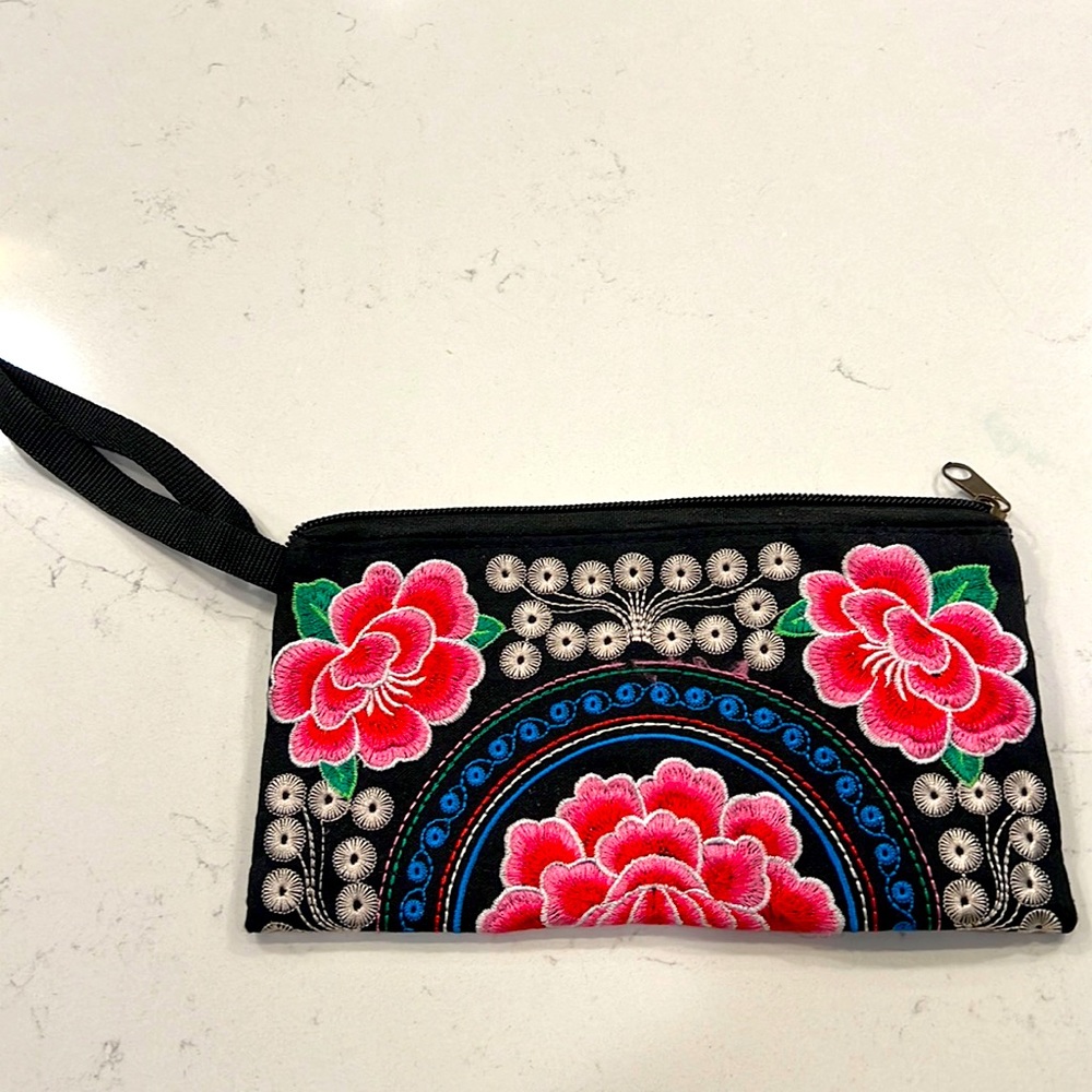 Embroidered wristlet with peony design.